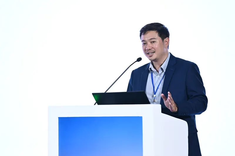 Arnon Tawong presenting THINCQ at a podium at the BRIDGE-AI Summit 2026