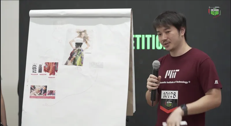 Arnon Tawong pitching with a microphone beside a flip chart at TechJam 2018
